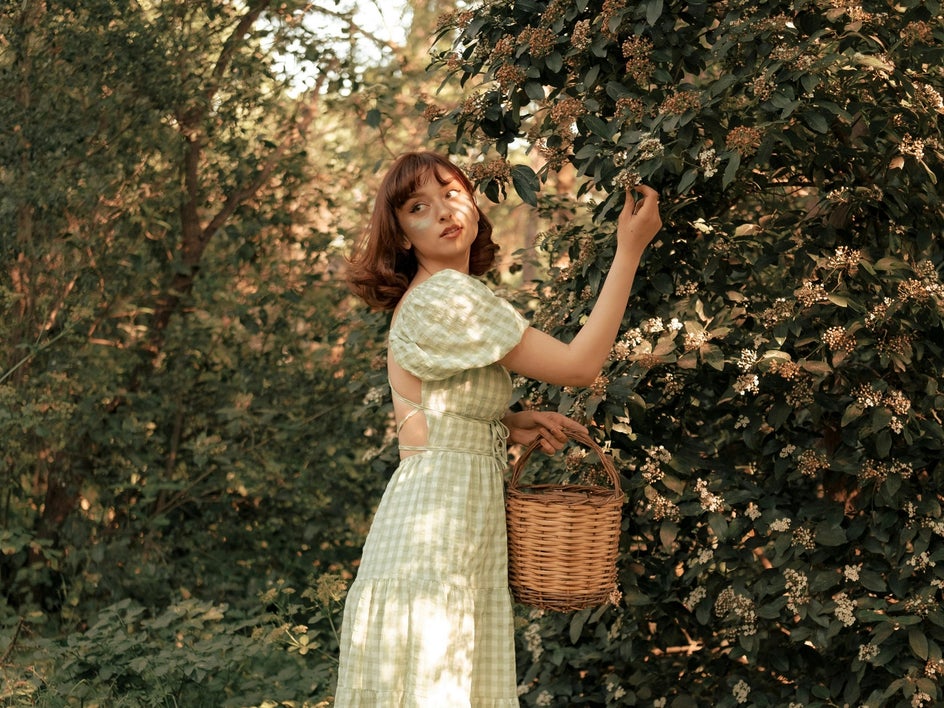 before: female portrait in orchard with long gingham dress