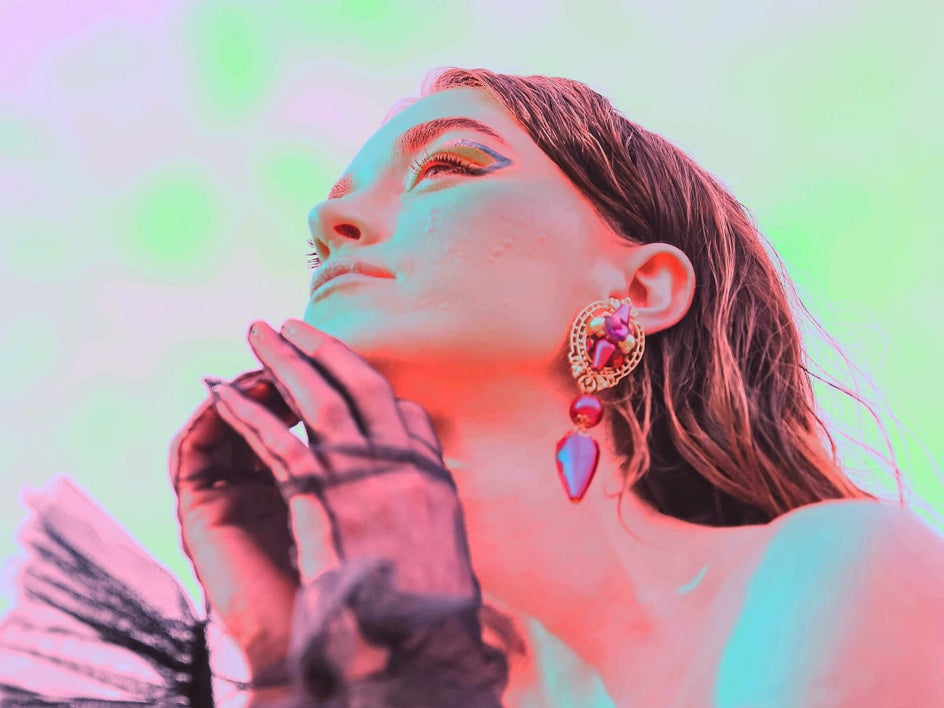 after: same portrait with solarize applied to create a neon pink and green effect