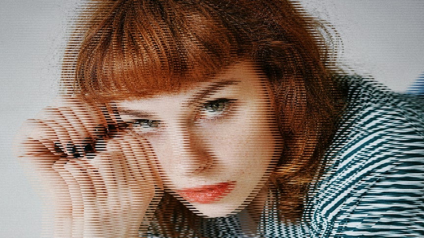 A portrait of a redheaded woman with the Interlace effect applied